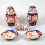 Pair of Imari covered vases, two small Imari bottle vases, three bowls, plates and dishes.