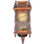 Small Vienna type wall clock, beech case, the movement striking on a gong, approximately 56cm.