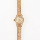 Longines - a lady's 9 carat yellow gold bracelet watch, circular light champagne baton dial in a 9