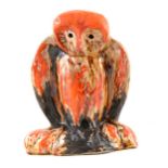 Eric Leaper, a large pottery model of an owl on a branch, running burnished orange glaze over a