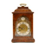 An Elliott walnut cased bracket clock, brass dial with silvered roman numeral chapter ring, keyless