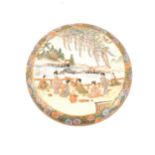 A Japanese satsuma circular covered dish, cover depicting women by waterside with wisteria above