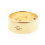 An 18 carat yellow gold wedding band star gypsy set with a small old brilliant cut diamond,