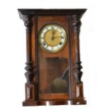 A walnut cased Vienna type wall clock