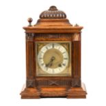 An oak cased mantel clock