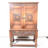 Reproduction carved oak cabinet on stand