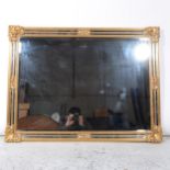 A reproduction gilt framed wall mirror