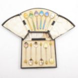 A cased set of silver gilt and enamelled teaspoons by Levi & Salaman, Birmingham 1925, and a cased