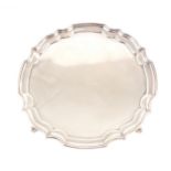 A silver salver by A Chick & Sons Ltd, Birmingham 1977, moulded pie-crust edge, four scrolled feet,