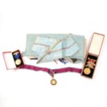 A large Masonic medal marked 9ct, two medals, various certificates, rule books, etc. two cases.