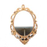 Oval wall mirror with gilt gesso frame.