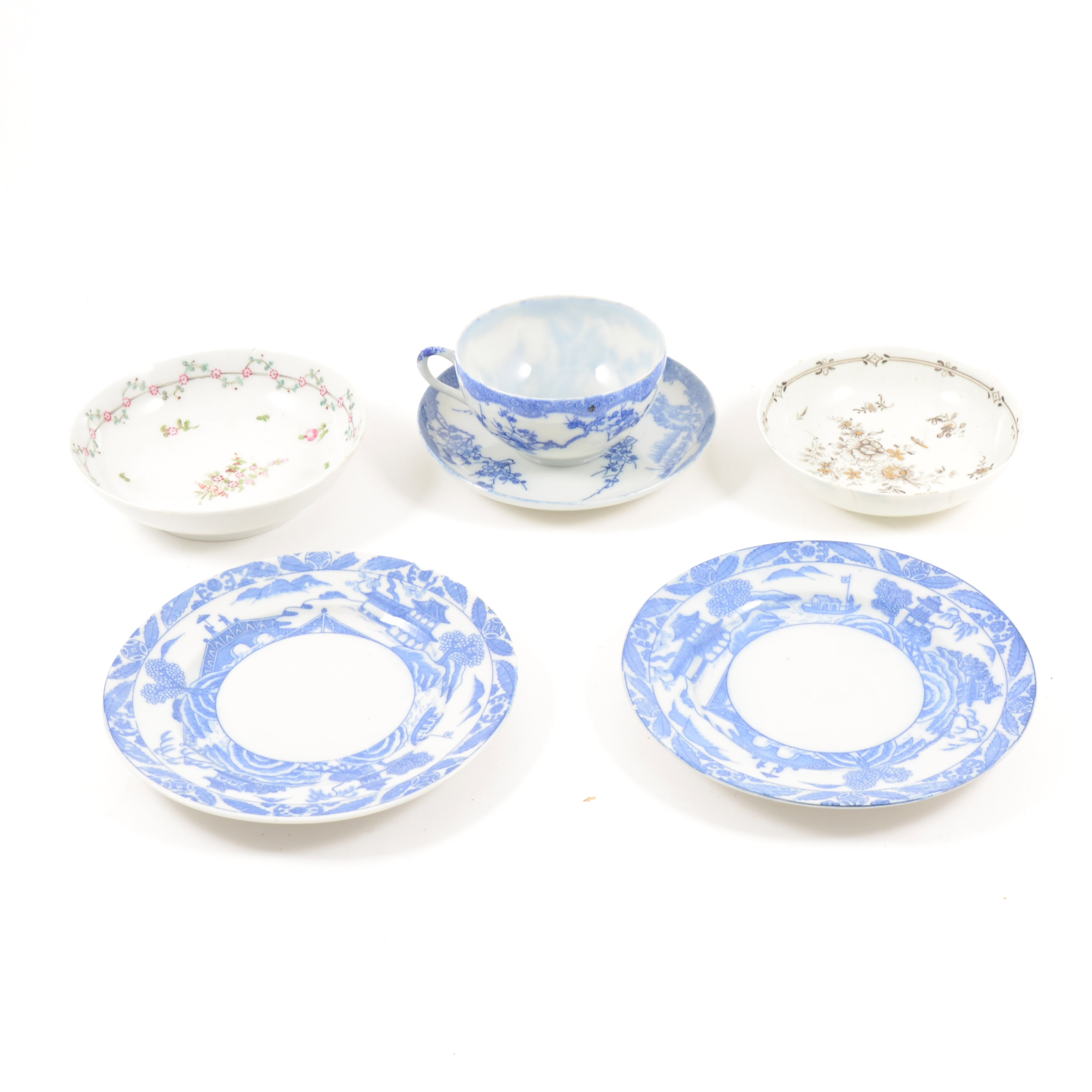 A late Chinese blue and white cup and saucer, and a collection of English porcelain saucers