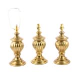 Three lacquered brass lamp bases, and an opaque glass shade.