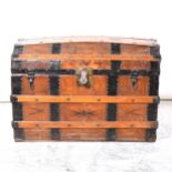 Vintage leather and metal strapped dome-topped trunk.