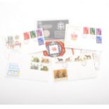 Small selection of stamps, first day covers and commemorative coins.