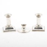 A pair of silver candlesticks and capstan ink well