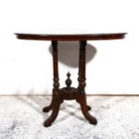 An oval occasional table on four turned supports with centre finial.86cm x 52cm