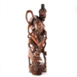 Chinese carved hardwood figure of an immortal, with a Temple dog, adapted as a table lamp.