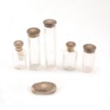 Five silver capped dressing table set bottles and a matching lid by Adie Brothers Ltd,