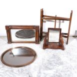 An oak circular butler's table, a mahogany wall mirror and a mahogany toilet mirror