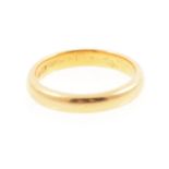 A yellow metal wedding band,