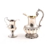 A Victorian silver cream jug and a William IV silver creamer jug