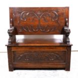 Carved oak monks bench, folding top, box base, 104cm.