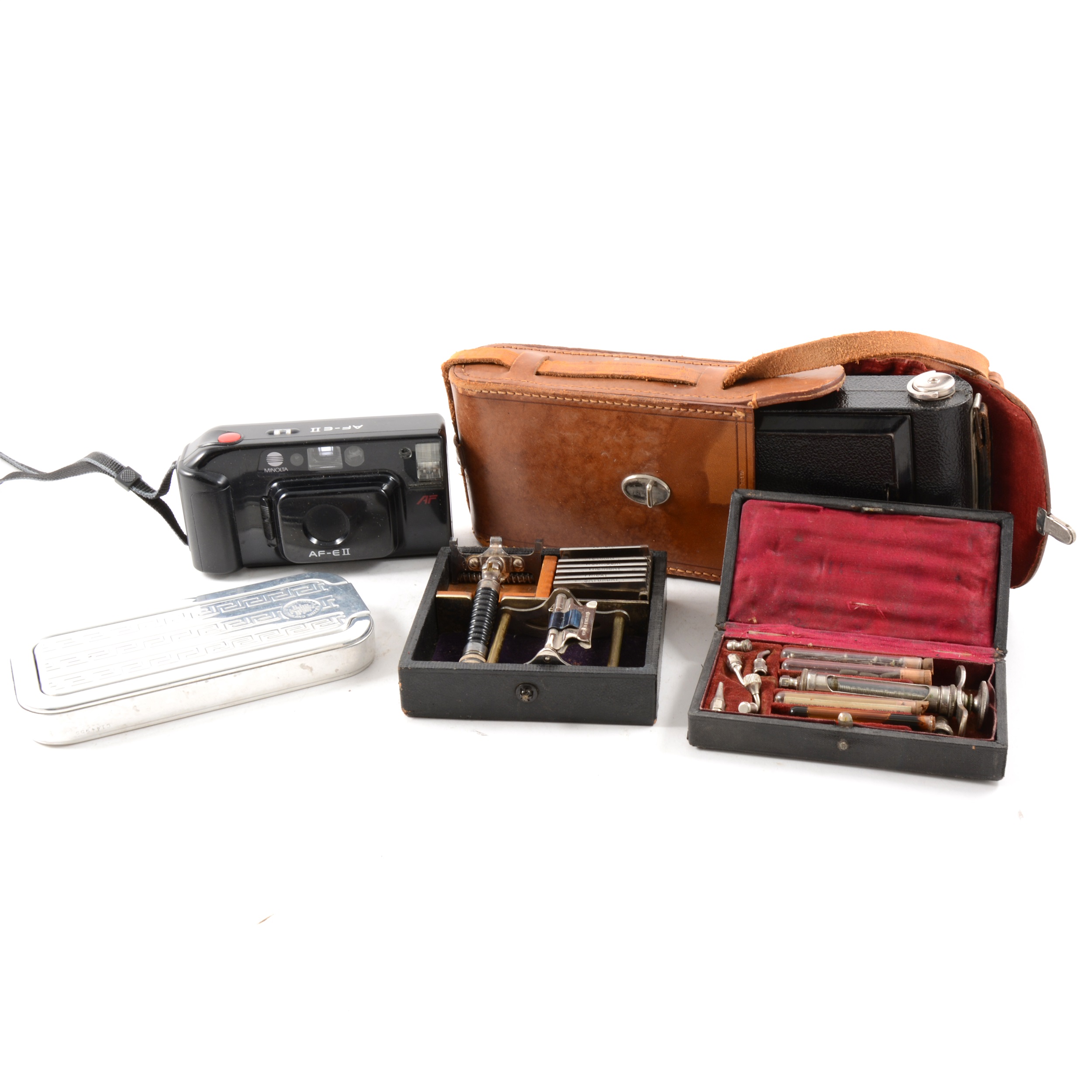 A Kodak Six-16 junior Camera in leather case, dentist's syringe set in case, a brass mounted