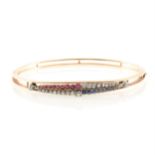 A Victorian Jubilee bangle set with diamonds, sapphires and rubies,