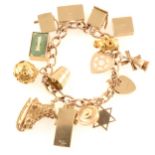 A gold charm bracelet and charms, total gross weight approximately 66.3gms.