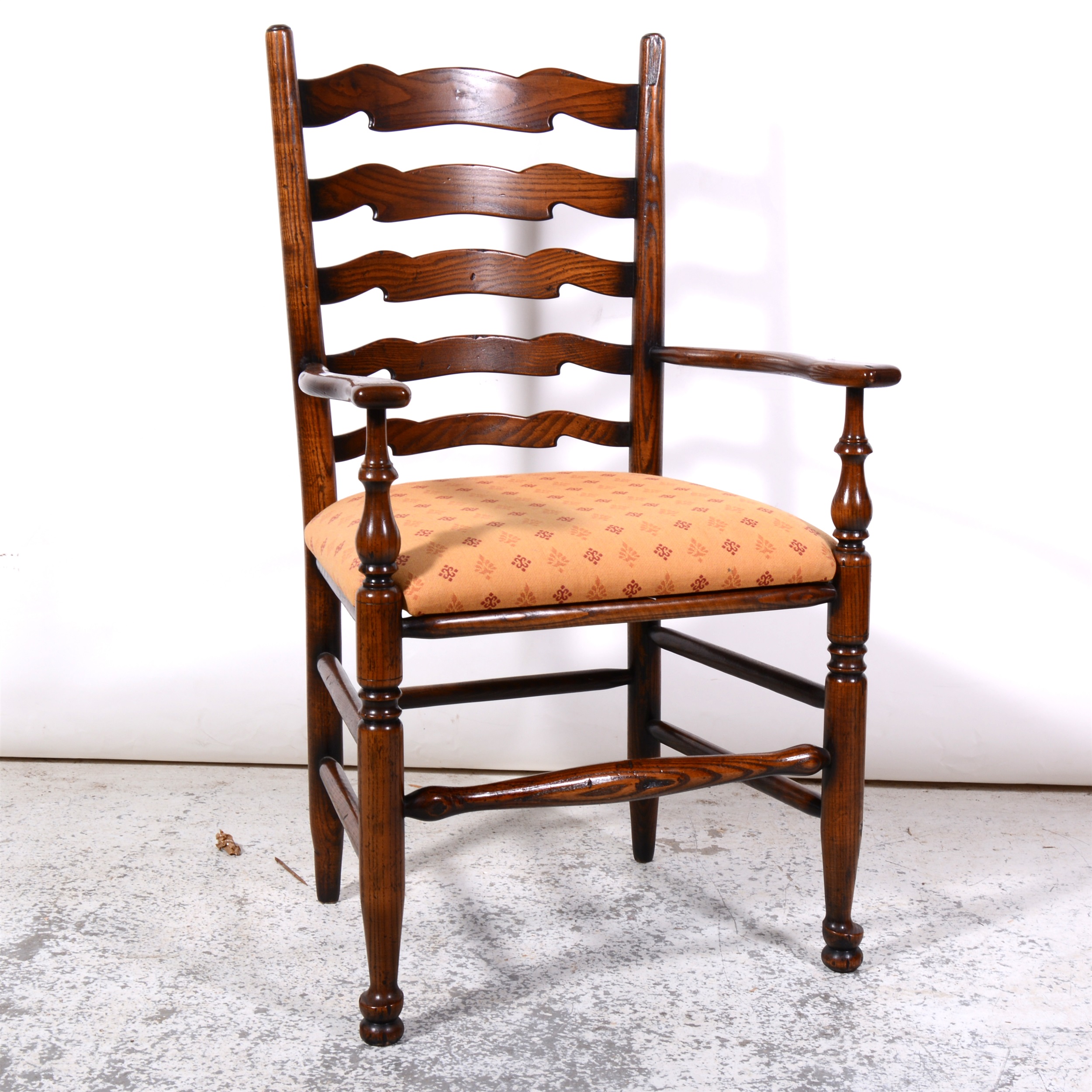 Elm and ash ladder-back elbow chair, 19th Century, shaped arms, upholstered drop-in seat, turned