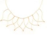 A fine yellow metal fringe necklace marked 750.