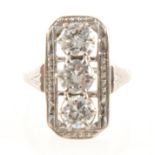 A diamond three stone ring in the Art Deco style