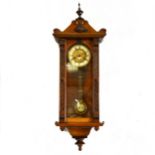 Walnut Vienna type wall clock, carved case, circular dial, the movement striking on a gong.