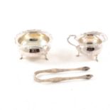 Silver milk jugand sugar bowl and a pair of sugar tongs,