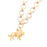 A 9 carat yellow gold circular link bracelet with lion charm