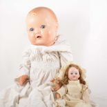 A German bisque head doll, fixed eyes, open mouth, composition jointed body; and another