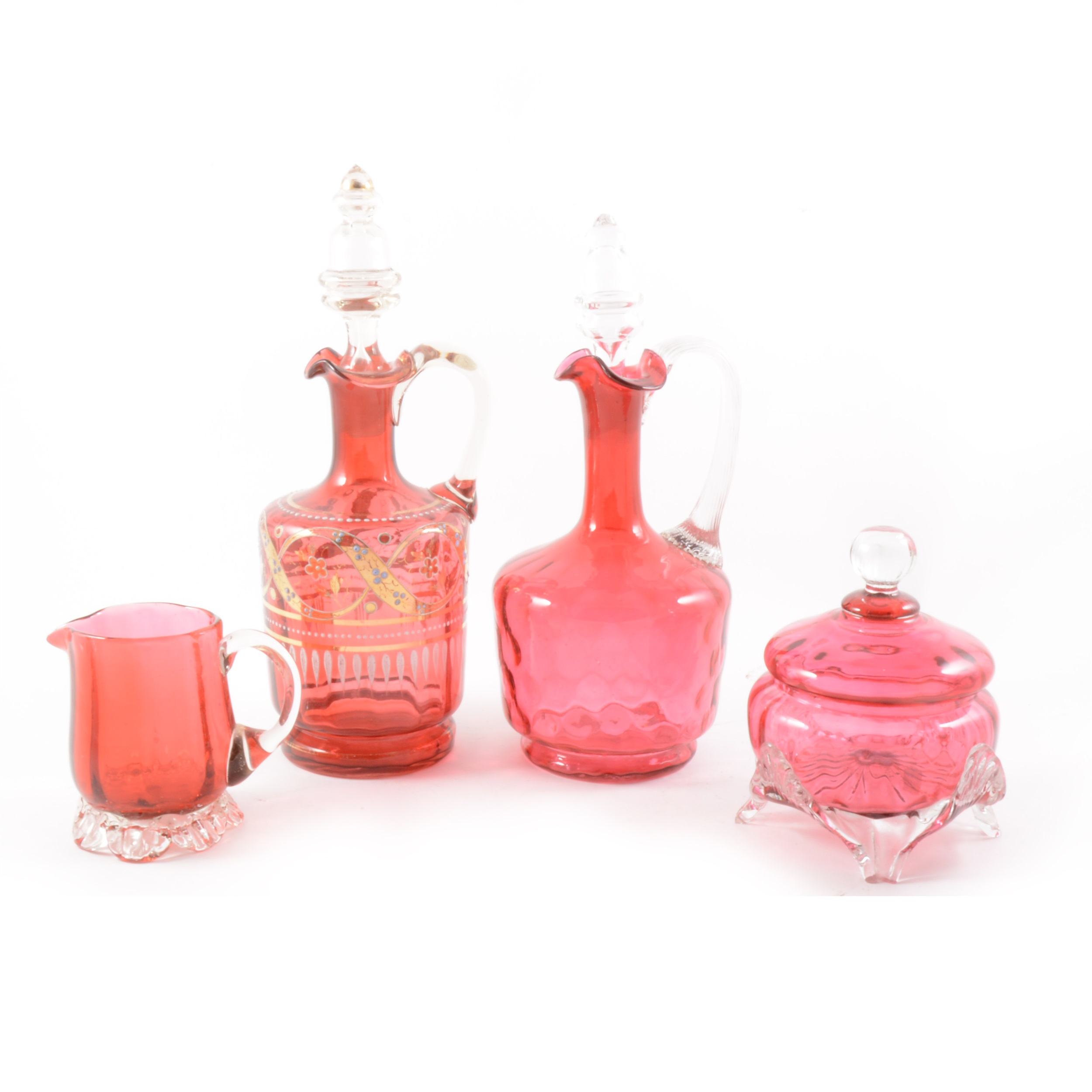 A Cranberry glass claret jug and other cranberry items