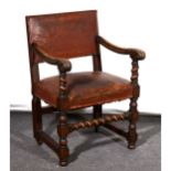 A Restoration style stained and carved wood elbow chair