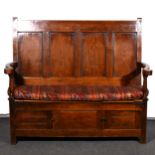 A joined oak settle, four panelled back