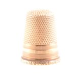A yellow metal thimble, marked 585
