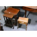 A nest of three stained wood occasional tables