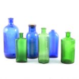 Collection of coloured glass chemist's bottles