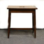 A mahogany stool, rectangular top with a hand-hold