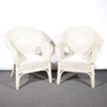 A pair of white painted woven cane conservatory chairs