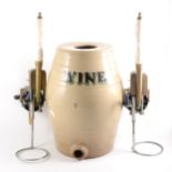 Two beer pumps, and a stoneware wine barrel