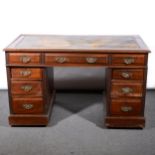 An Edwardian walnut twin pedestal desk