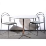 A chrome bar table, with four tubular stacking chairs