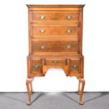 A reproduction walnut finish chest on stand