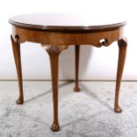 A walnut occasional table, circular top with cross-banding